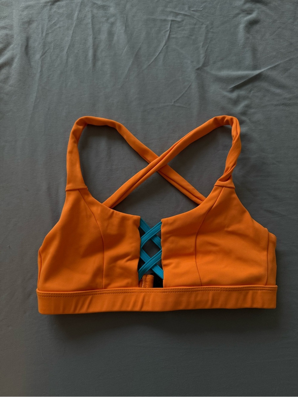 Women’s Orange Strappy Sports Bra with Teal Crisscross